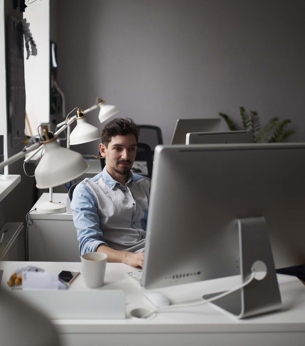 young-intelligent-bearded-man-working-at-modern-lo-ZMWRQLS.jpg